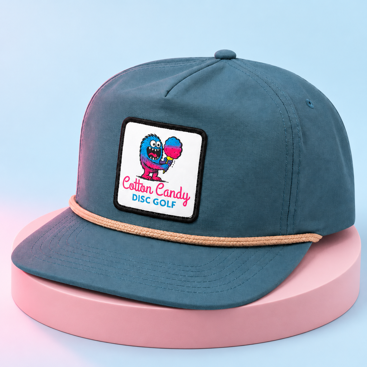 Slate blue Cotton Candy rope hat on a pink studio plinth